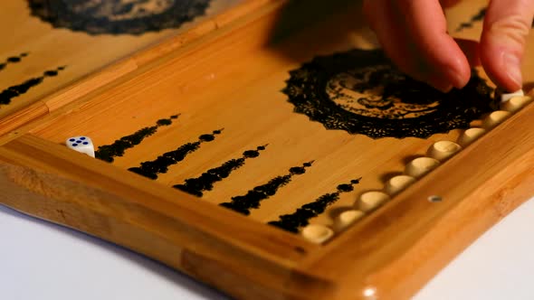 The Player Takes Three Five Dice From the Backgammon Board