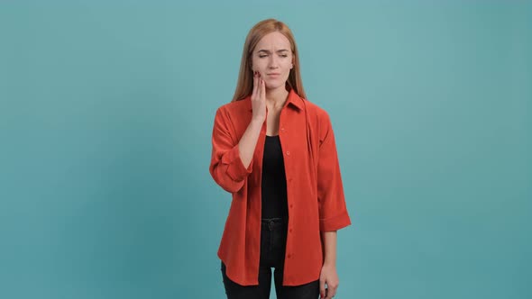 Beautiful Woman Isolated on Turquoise Background Suffering From Severe Toothache