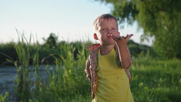 Baby Food Adorable Male Child Hides an Apple Behind His Back and Then Bites a Ripe Juicy Fruit