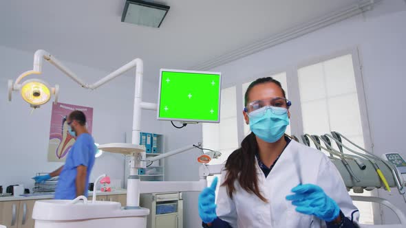 Patient Pov of Dentist Explaining Problem Using Greenscreen Monitor