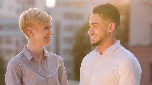 Multiracial Business Colleague Couple Arabic Hispanic Man and Mature Caucasian Woman Standing