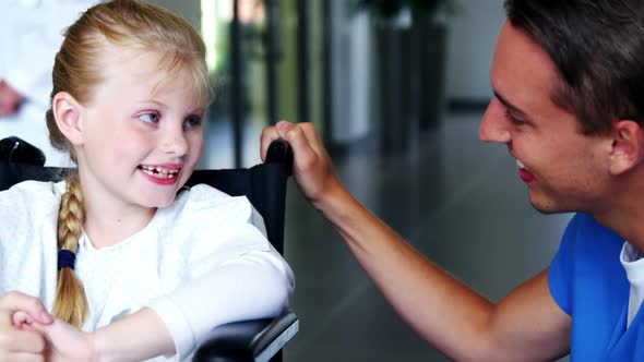 Doctor interacting with disable girl