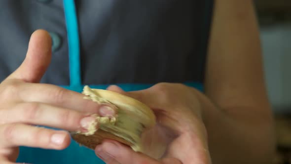 Female Baker Hands Filling Cookie with Cream