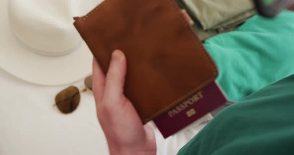 Albino african american man holding smartphone with covid 19 vaccine passport