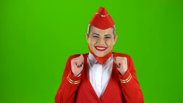 Girl Dressed in Red Rejoices in Victory. Green Screen