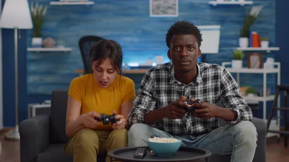 Modern Interracial Couple Losing Video Game on TV