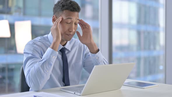 Tired African American Businessman Having Headache in Office  