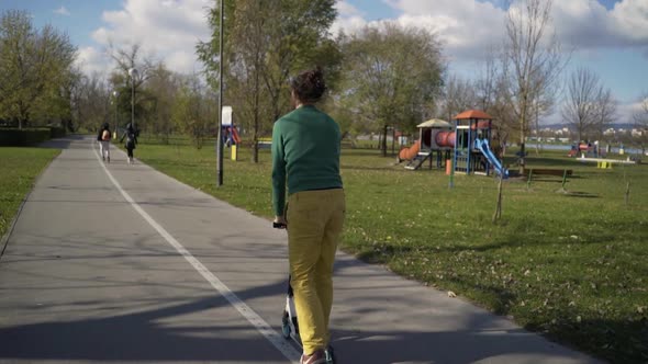 Man riding on scooter in public playground, Zagreb, Croatia.