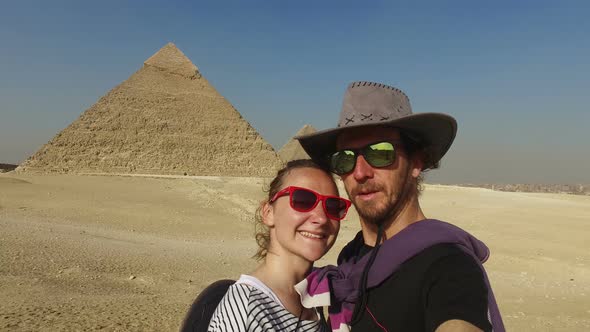 Happy couple in front Giza pyramids