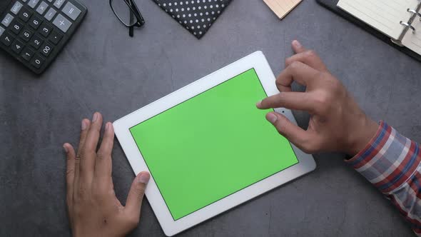 Man's Hand Working on Digital Tablet at Office Desk, Top View 