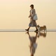 Dog and Woman Happy Walk Along Beach in Autumn Spbi - VideoHive Item for Sale