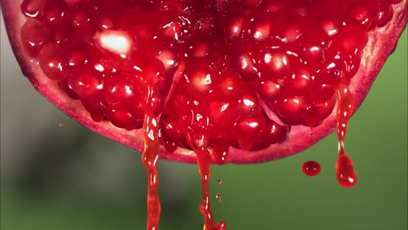 Flowing Pomegranate Juice From Half Pomegranate Macro Shot in Slow Motion