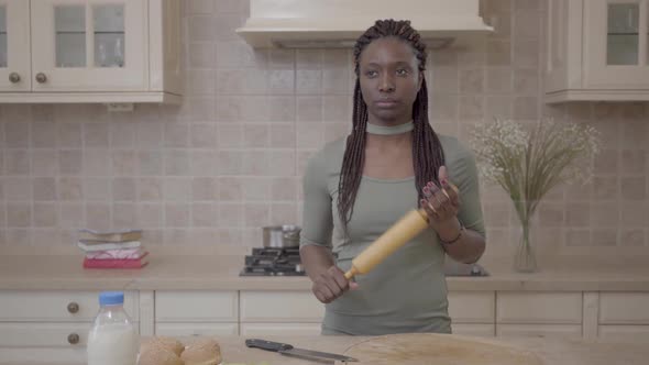 American African Beautiful Woman Standing with Rolling Pin and Thinking About Pie Preparing on the