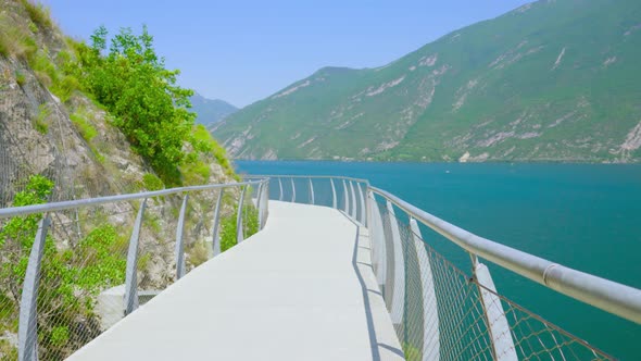 Road Suspended on the Mountain Rocks to the Lake in the Alps