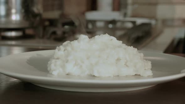 Chef pours risotto into the pot, Italian recipe