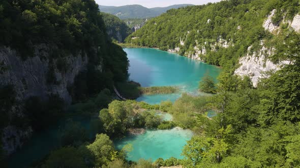 Top view of the beautiful Plitvice Lakes National Park with many green plants and beautiful lakes an