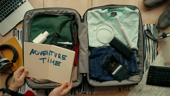 Man Packs Suitcase Ready for Adventure Travel Trip