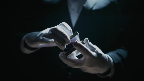Closeup of a Suited Magician's Hands Performing Sleight of Hand Card Tricks