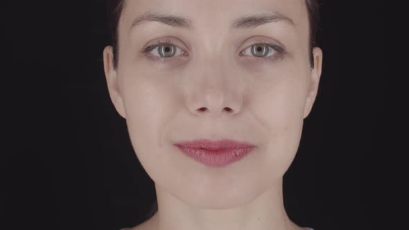 Smiling Female Face on Dark Background