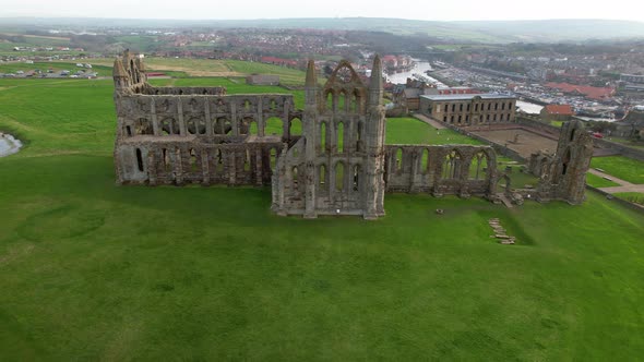 Historic Whitby Abbey Ruins With Seaside Town In The Background In North Yorkshire, England, UK. - a