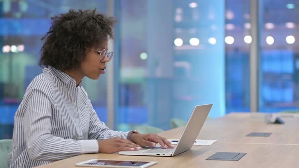 Tired African Businesswoman with Laptop Having Back Pain in Office 