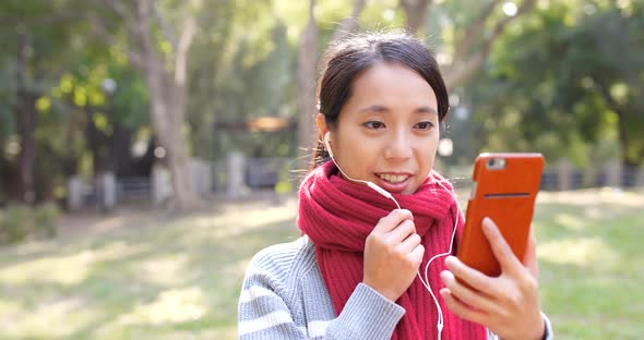 Woman making video call in the park