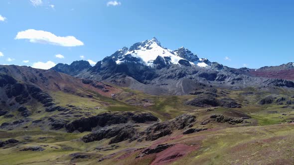 Drone video of a snow mountain peak in the andes, in Peru. Called "Rajuntay" Flying forward over roc