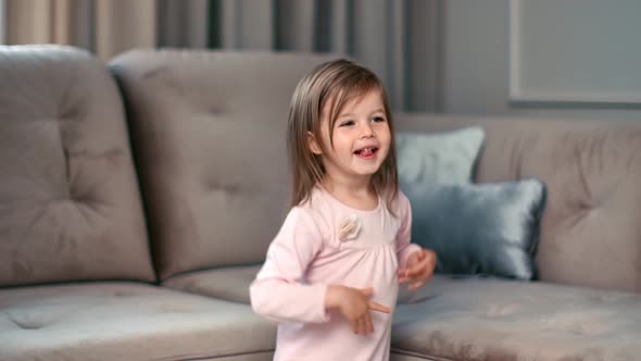 Cute Girl Dancing Clapping Hands Having Positive Emotion at Home