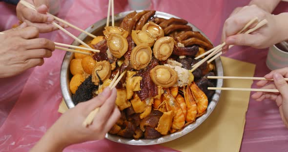 Traditional Chinese family eating big bowl feast together