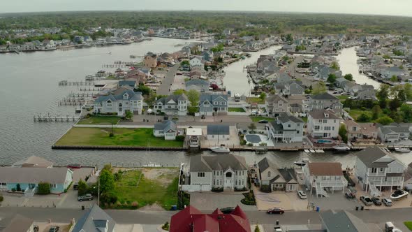 Aerial Drone Wide Shot of Local Residential Suburb of River in View of Distant Toms River
