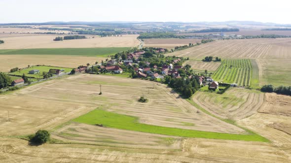 Aerial Drone Shot  a Village Surrounded By Fields and Forests in a Rural Area