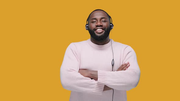 Smiling African American Man Wearing Wireless Headset Looking at the Camera, Call Center Service