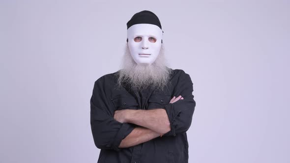 Mature Bearded Hipster Man Wearing White Mask As Halloween Concept