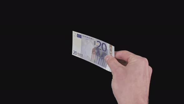 Male Hand Shows a Banknote of 20 Euros with Alpha Channel