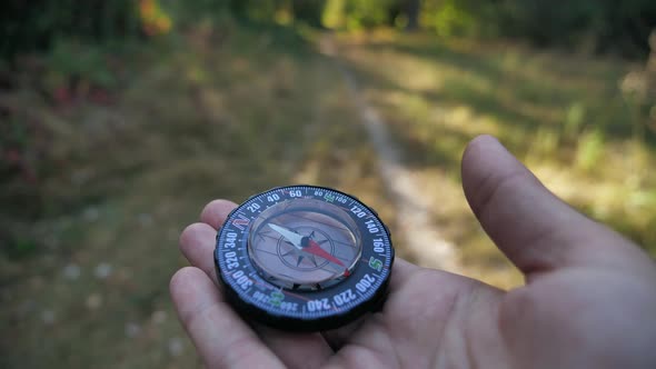 Compass in the Hands of a Man Close Up 