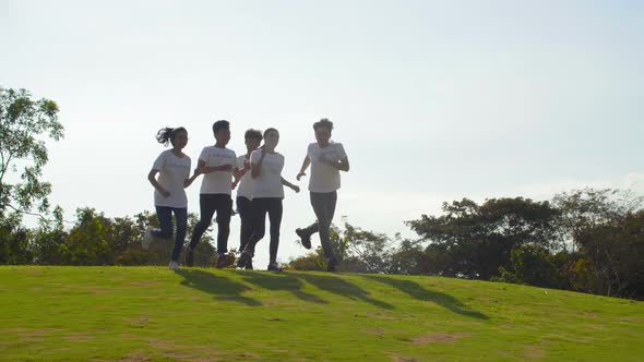 Joyful Volunteers Running in Park