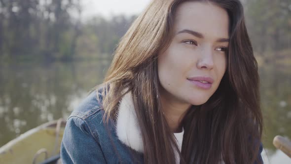 Portrait of Young Brunette in Jeans Jacket Looking in the Camera