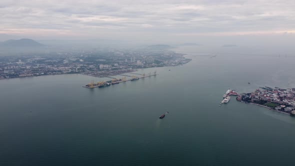 Aerial view panning right of ship vessel move at Penang sea.