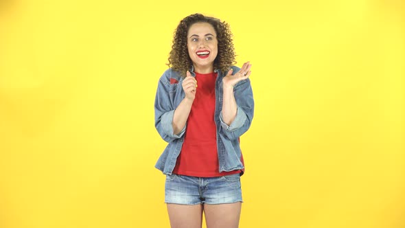 Young Girl Thinks About Something, and Then an Idea Comes To Her Against Yellow Background