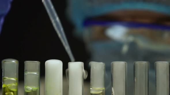 Researcher Taking Test Tube With Blue Boiling Liquid, Analyzing Sediments