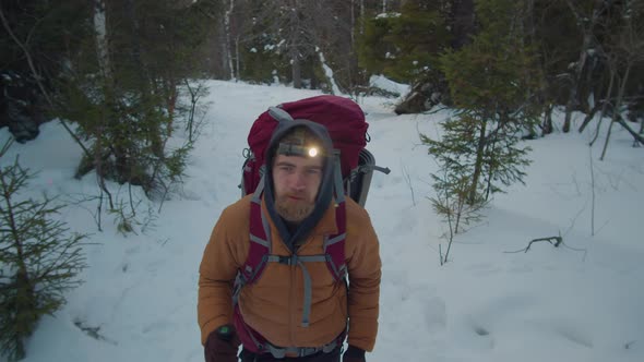 Man with Headlamp Hiking in Evening