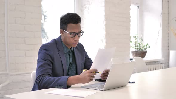 African Man Reading Contract, Paperwork