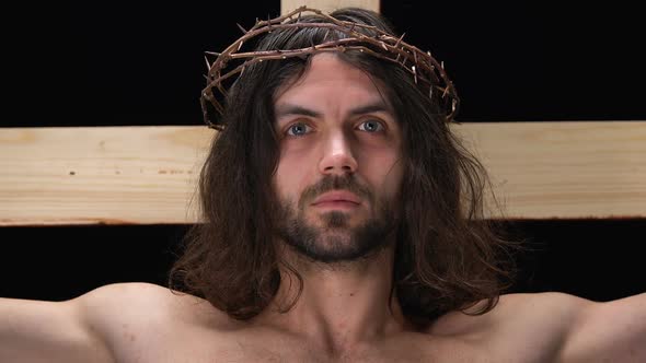 Jesus in Crown of Thorns Crucified on Cross Looking at Camera, Saving From Sins