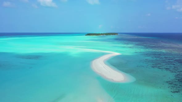 Aerial scenery of tranquil coastline beach voyage by aqua blue ocean and white sand background of a 