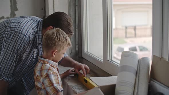 Little Boy Renovating House with Dad alt