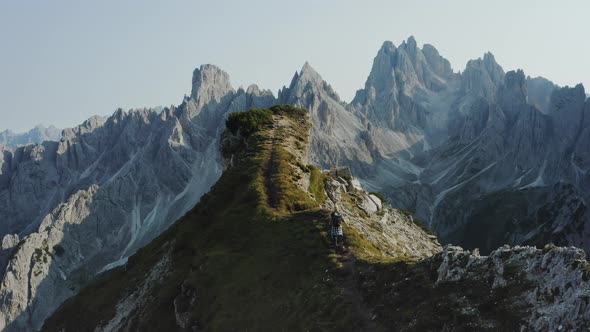 Women Walks Along Cliff Edge