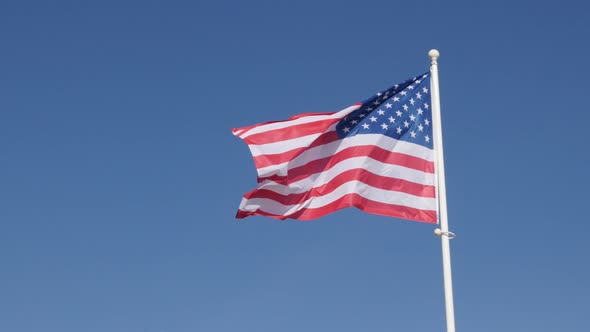 Famous American flag waving in front of blue sky 4K 2160p 30fps UHD footage - Recognaizable flag of 