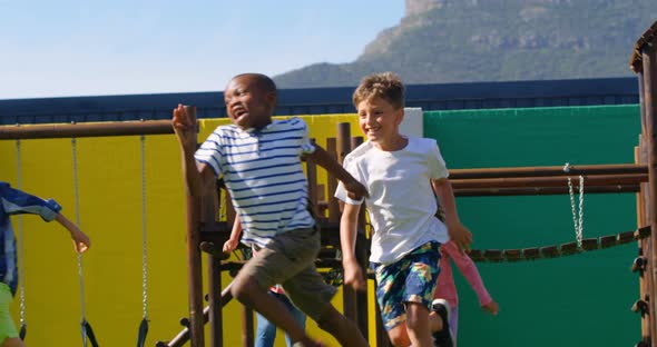 Front view of mixed-race schoolkids playing in the school playground 4k