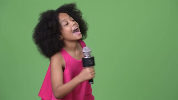 Young Cute African Girl with Afro Hair Singing Happily