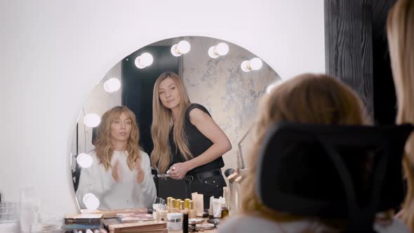 Lady on Chair and Young Woman Near Mirror